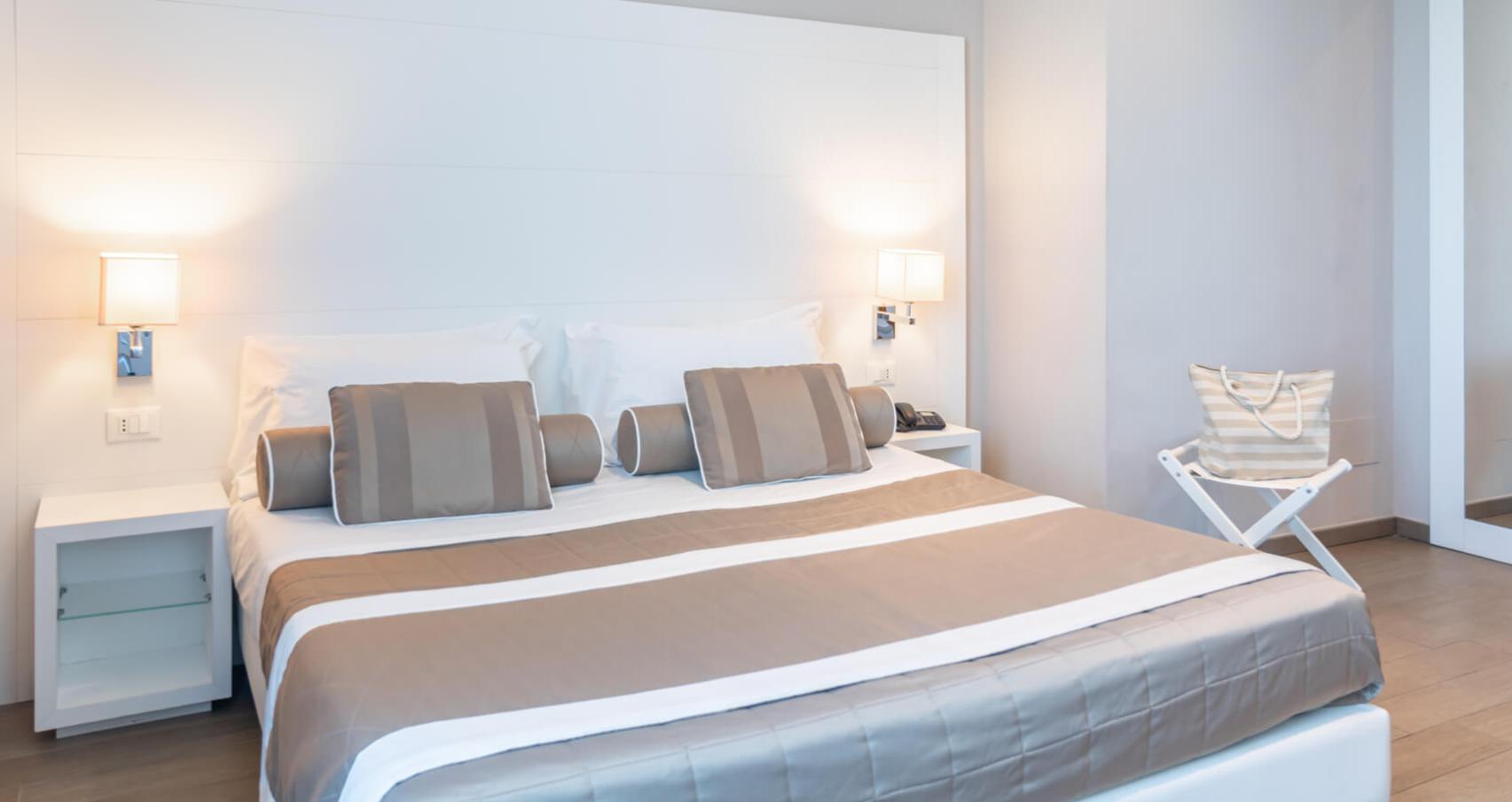Modern room with a double bed, soft lighting, and elegant decor.