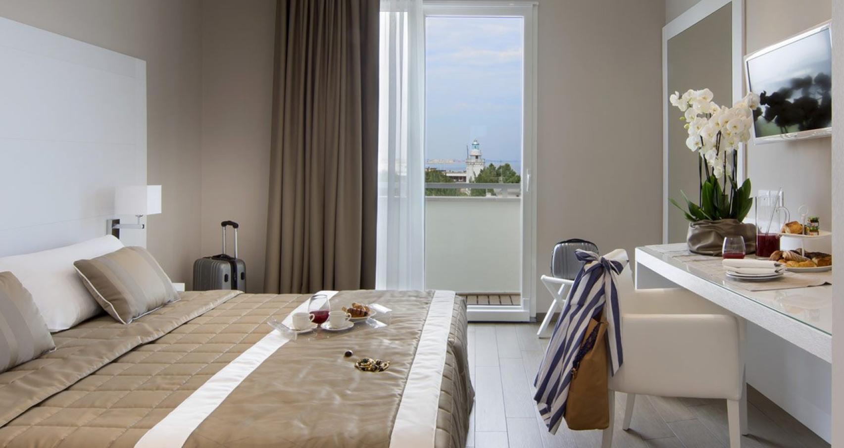 Elegant hotel room with sea view and breakfast served in-room.