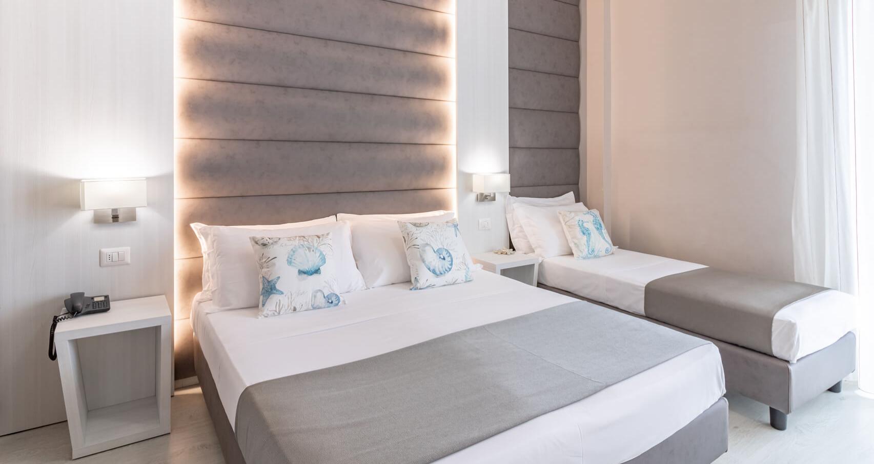 Modern room with double bed, soft lighting, and bedside tables.